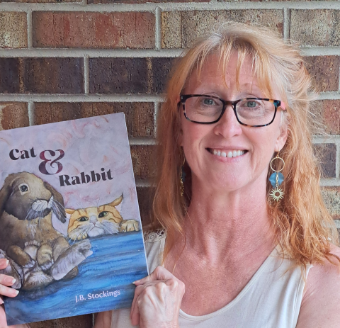 Jodi Bowersox holding her latest children's book, Cat & Rabbit